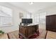 Bright office featuring hardwood floors, two windows and a closet at 200 Cloud Berry Ln, Holly Springs, NC 27540