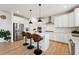 Modern kitchen with white cabinets, stainless steel appliances, and center island with bar stools at 200 Cloud Berry Ln, Holly Springs, NC 27540