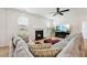 Comfortable living room with a fireplace, modern ceiling fan and lots of natural light at 200 Cloud Berry Ln, Holly Springs, NC 27540