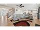 Open-concept living room with hardwood floors, decorative rug and adjacent kitchen at 200 Cloud Berry Ln, Holly Springs, NC 27540