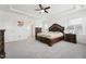 Large main bedroom with decorative tray ceiling, carpeting, ceiling fan and neutral paint scheme at 200 Cloud Berry Ln, Holly Springs, NC 27540