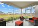 Covered sunroom with chairs and an outside view to the backyard and neighborhood at 200 Cloud Berry Ln, Holly Springs, NC 27540