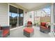 Covered sunroom with chairs, open sliding glass doors and outside view to the yard at 200 Cloud Berry Ln, Holly Springs, NC 27540