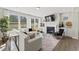 Bright living room with a fireplace, TV, and large windows at 2012 Kapalua Way # 193, Durham, NC 27703