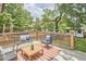 Enjoy outdoor living on this spacious back deck with stylish furniture and a view of the landscaped yard at 2031 Englewood Ave, Durham, NC 27705