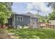 Stylish home featuring well-maintained lawn, back deck, and a sleek gray exterior at 2031 Englewood Ave, Durham, NC 27705