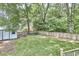 Spacious backyard featuring a shed, a wooden fence, and mature trees, perfect for outdoor enjoyment at 2031 Englewood Ave, Durham, NC 27705