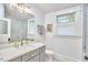 Modern bathroom featuring glass-enclosed shower, white countertops, gray vanity, and tiled floor at 2031 Englewood Ave, Durham, NC 27705