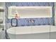 Close-up of a luxurious white bathtub with modern fixtures and stylish blue accent tiles at 2031 Englewood Ave, Durham, NC 27705