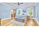 Serene bedroom with blue walls, hardwood floors, and a stylish barn door leading to the bathroom, offering comfort and privacy at 2031 Englewood Ave, Durham, NC 27705