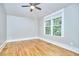 Spacious bedroom features hardwood floors, a ceiling fan, and a bright window at 2031 Englewood Ave, Durham, NC 27705