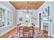 Dining room features wood ceiling, chandelier, and fireplace, with hardwood floors and a large rug at 2031 Englewood Ave, Durham, NC 27705