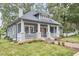 Inviting home with a classic front porch, fresh landscaping, and a brick walkway at 2031 Englewood Ave, Durham, NC 27705