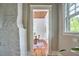 Hallway shot of a dining room with wood ceiling, rug, and table, with a brick column to the side at 2031 Englewood Ave, Durham, NC 27705