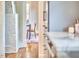 Inviting hallway with hardwood floors leads to a sunlit dining area, showcasing the home's charming interior design at 2031 Englewood Ave, Durham, NC 27705
