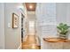 Hallway boasting a custom-built white brick fireplace with wood accents and hardwood floors at 2031 Englewood Ave, Durham, NC 27705