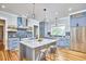 Modern kitchen with gray cabinets, marble countertops, stainless steel appliances, and a kitchen island at 2031 Englewood Ave, Durham, NC 27705