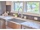 Beautiful kitchen with stainless steel farmhouse sink, marble countertops, and gray cabinets at 2031 Englewood Ave, Durham, NC 27705