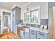 Bright kitchen with marble countertops, farmhouse sink, stainless steel appliances, and ample cabinet space at 2031 Englewood Ave, Durham, NC 27705
