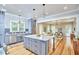 Open kitchen with island, marble countertops, stainless steel appliances, and easy access to the living room at 2031 Englewood Ave, Durham, NC 27705
