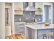 Updated kitchen featuring marble countertops, gray cabinets, stainless steel range, and floating wood shelves at 2031 Englewood Ave, Durham, NC 27705