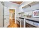Well-appointed laundry room features modern washer/dryer, marble countertop, custom cabinets, and stylish decor at 2031 Englewood Ave, Durham, NC 27705