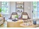 Cozy sitting area with stylish wicker chairs, a modern shelf, and ample natural light, creating a relaxing atmosphere at 2031 Englewood Ave, Durham, NC 27705