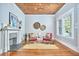 Bright living room features a wood ceiling, fireplace, decor, and two pink chairs with green pillows at 2031 Englewood Ave, Durham, NC 27705