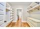 Bright walk-in closet featuring custom shelving, drawers, and hardwood floors, perfect for organized storage at 2031 Englewood Ave, Durham, NC 27705