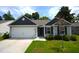 Single-story home featuring attached garage, light gray siding, black shutters, and well-kept lawn at 2039 Alderman Way, Creedmoor, NC 27522