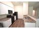 Modern kitchen features white cabinets, granite countertops, dark appliances and wood-look floors at 2039 Alderman Way, Creedmoor, NC 27522