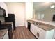 Modern kitchen features white cabinets, granite countertops, dark appliances and wood-look floors at 2039 Alderman Way, Creedmoor, NC 27522
