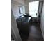 Well-lit laundry room features modern washer/dryer, built-in shelf and wood-look tile at 2039 Alderman Way, Creedmoor, NC 27522