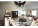 Spacious, virtually staged living room with a high ceiling, modern furniture, and lots of light at 2039 Alderman Way, Creedmoor, NC 27522