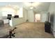 Open concept living space features white kitchen cabinets and view of the entryway and living room at 2039 Alderman Way, Creedmoor, NC 27522