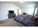 The main bedroom features a bed, and TV sitting atop a dresser, and carpeted floor at 2039 Alderman Way, Creedmoor, NC 27522