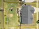 Aerial view showcases a spacious backyard featuring a playground, deck with pergola, and garden at 204 Ashland Hill Dr, Holly Springs, NC 27540