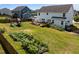 Expansive backyard featuring a playground, garden, pergola, and deck, ideal for entertaining at 204 Ashland Hill Dr, Holly Springs, NC 27540