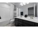 Bright bathroom with double sinks, a tub with white tile surround and blue accents at 204 Ashland Hill Dr, Holly Springs, NC 27540