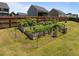 Backyard garden with raised beds, perfect for growing vegetables and flowers at 204 Ashland Hill Dr, Holly Springs, NC 27540