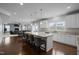 Modern open kitchen with a large island, stainless steel appliances, and seamless flow to the living area at 204 Ashland Hill Dr, Holly Springs, NC 27540