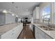 Open kitchen with granite countertops, stainless steel sink, and a view into the connected living area at 204 Ashland Hill Dr, Holly Springs, NC 27540