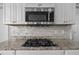 Modern kitchen featuring granite countertops, stainless steel appliances, and a gas cooktop at 204 Ashland Hill Dr, Holly Springs, NC 27540