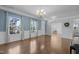 Elegant living room with hardwood floors, wainscoting, chandelier, and plenty of light at 204 Ashland Hill Dr, Holly Springs, NC 27540