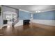 Elegant living room with hardwood floors, wainscoting, chandelier, and plenty of light at 204 Ashland Hill Dr, Holly Springs, NC 27540