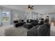 Spacious living room with a modern ceiling fan, neutral color palette, and comfortable seating arrangements at 204 Ashland Hill Dr, Holly Springs, NC 27540