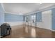 Elegant living room with hardwood floors, wainscoting, and chandelier lighting at 204 Ashland Hill Dr, Holly Springs, NC 27540