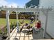 Relaxing outdoor lounge area with a pergola, picnic table, and comfortable hammock chairs at 204 Ashland Hill Dr, Holly Springs, NC 27540