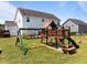 Backyard playground with slide, swing, and climbing area providing fun for children at 204 Ashland Hill Dr, Holly Springs, NC 27540