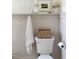 Toilet area with a towel, basket, and beadboard walls at 207 N Aiken St, Fuquay Varina, NC 27526